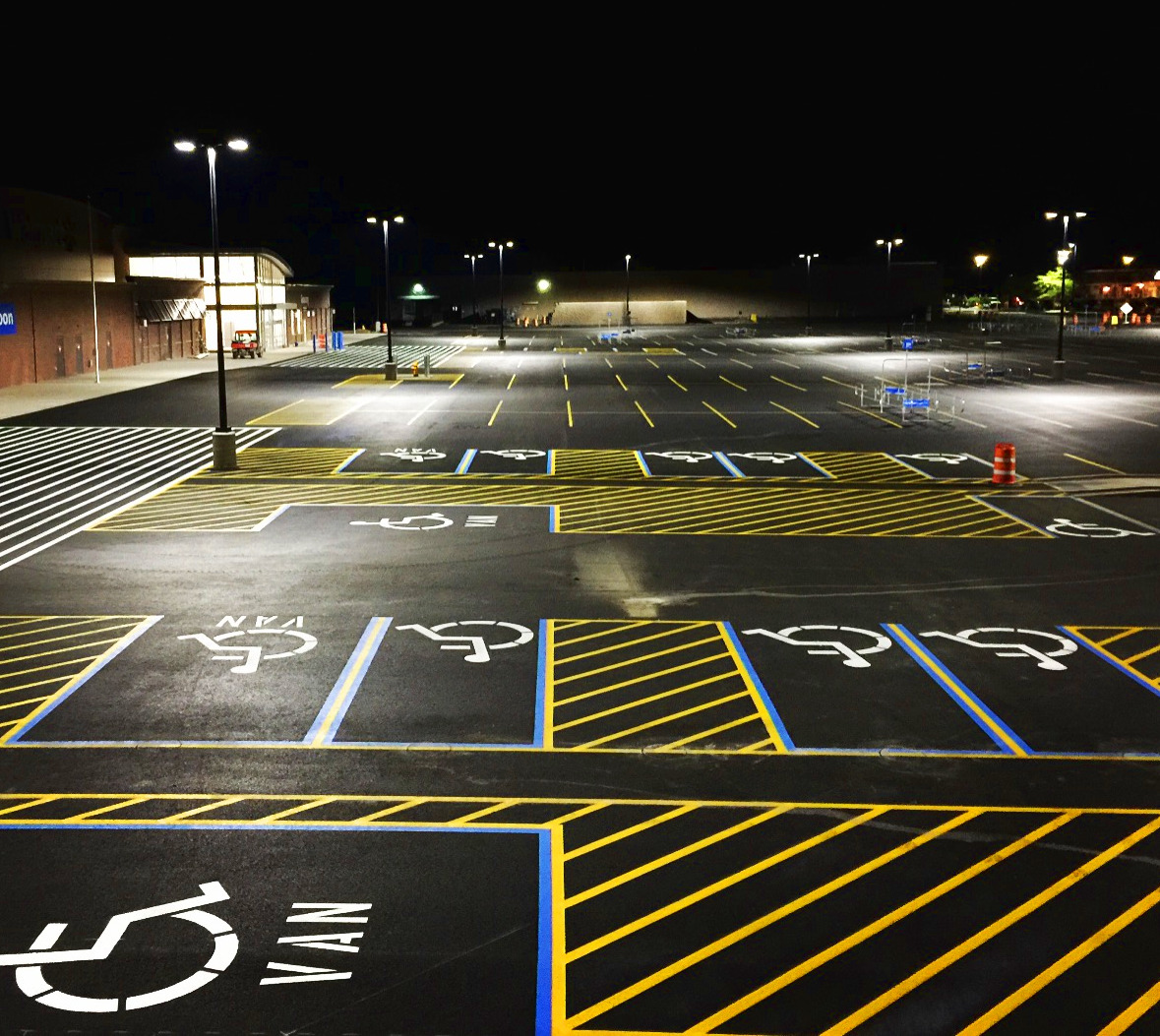 White pavement markings with yellow parking lot striping in Seattle, WA