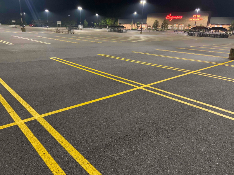 1-800-STRIPER | Parking Lot Striping in Woodinville, WA Fresh lines yellow lines on asphalt in a parking lot in Woodinville