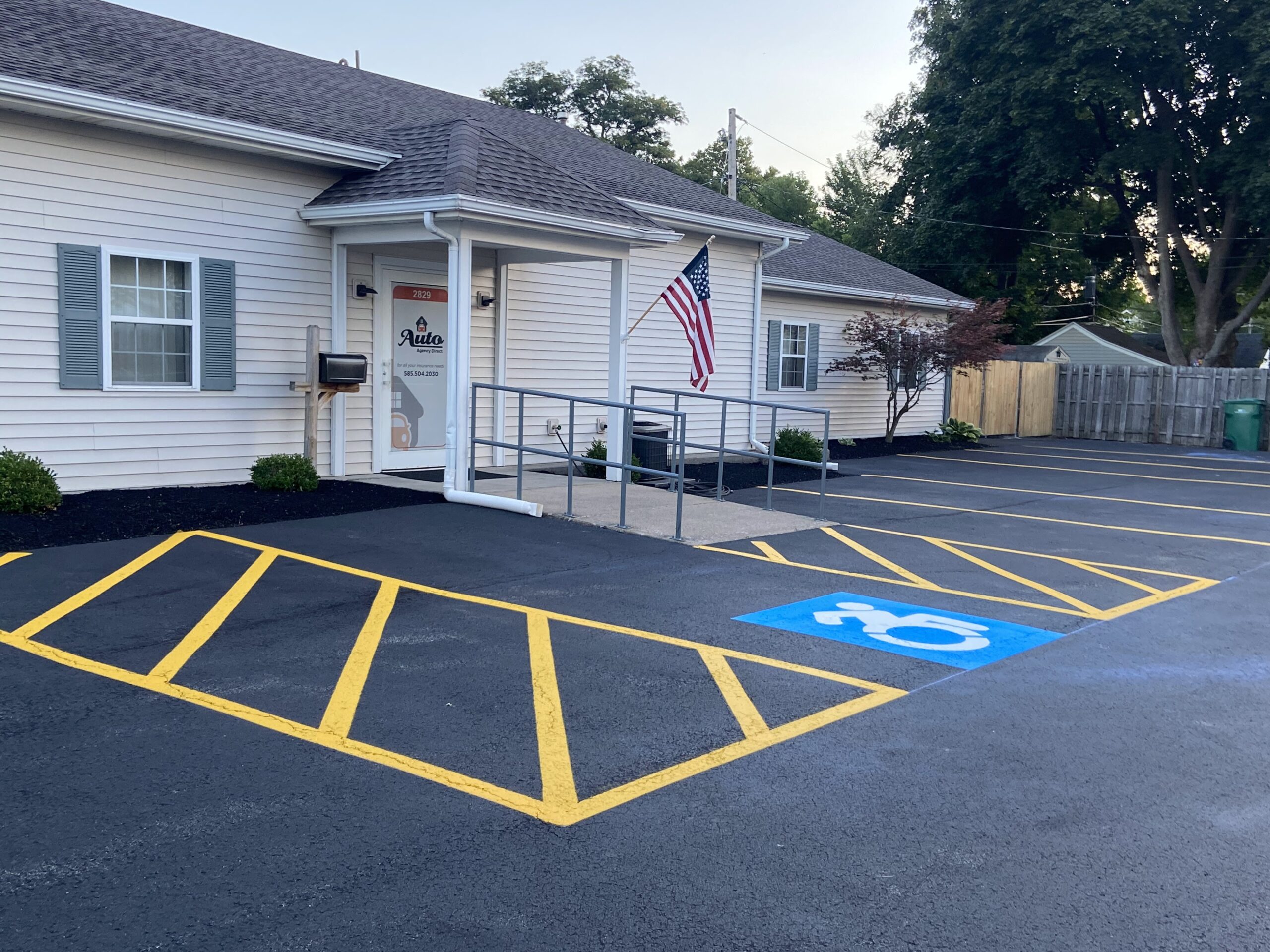 Spring maintenance in Seattle. Blue ADA handicap parking logo between two hash spaces made with parking lot line striping in Redmond, WA.