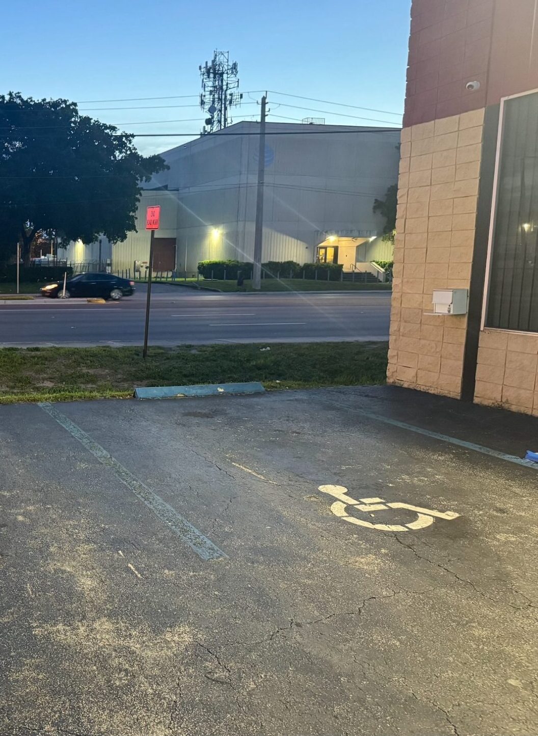 This ADA parking lot has faded paint, unclear handicap spaces, and no proper signage—putting property owners at risk of ADA non-compliance.