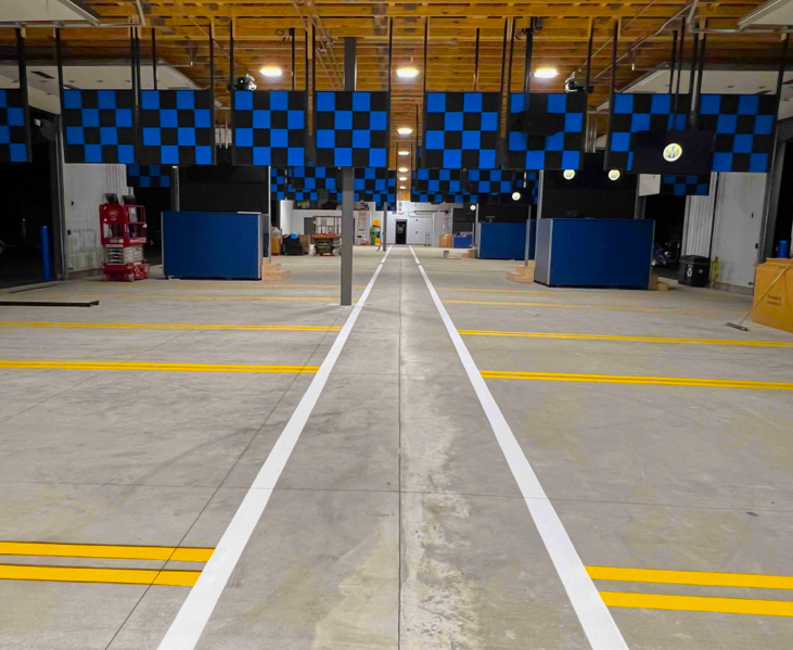 Indoor yellow and white striping on concrete in a warehouse in Kent, WA