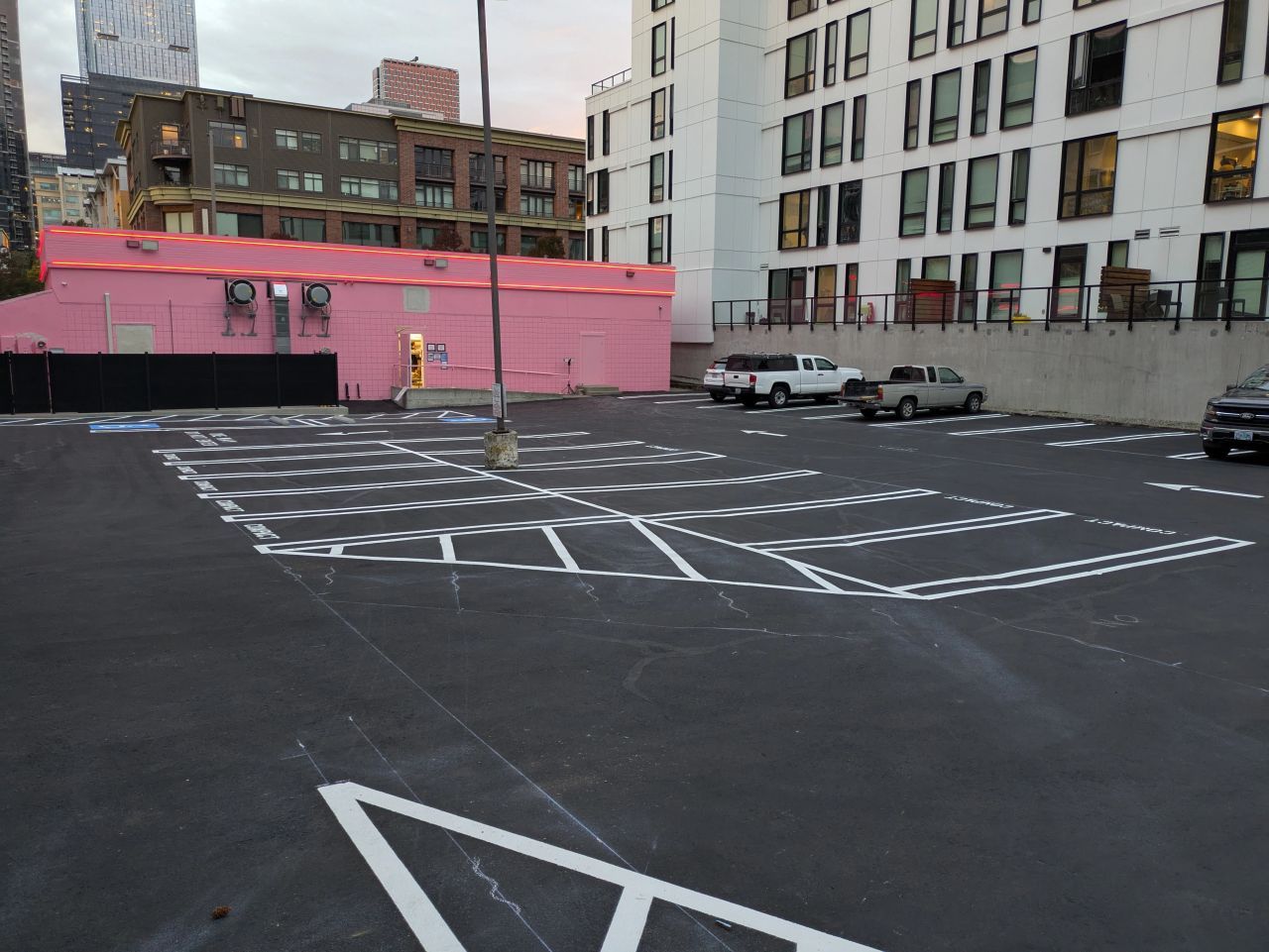 Sealcoating in Bellevue, WA behind a local Voodoo Doughnut. White line striping